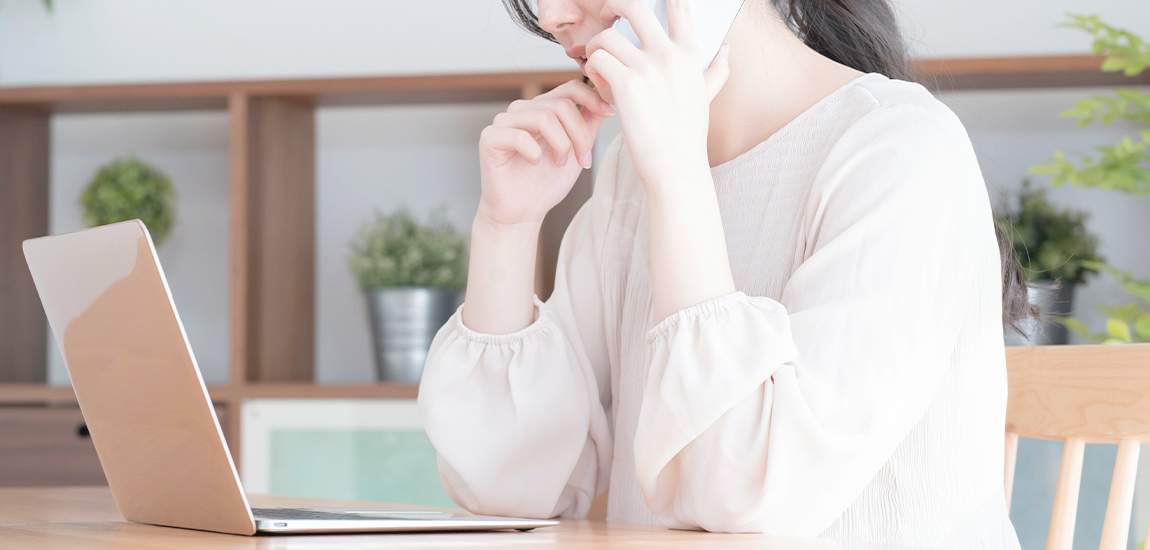 電話で問い合わせる女性